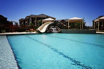 Expansive resort style pool and custom fountain, lounge deck, and cabanas